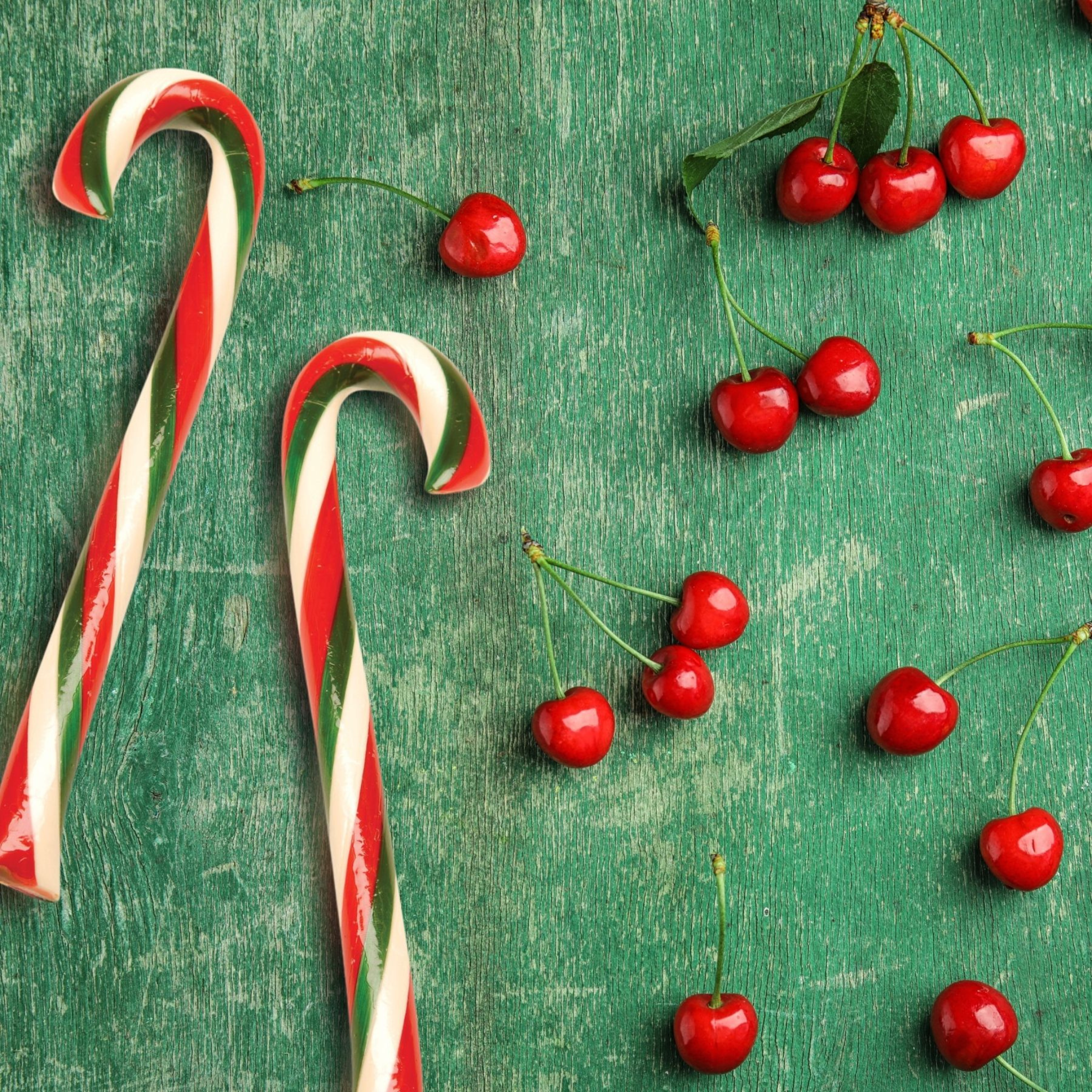 Cherry candy canes styled next to fresh cherries