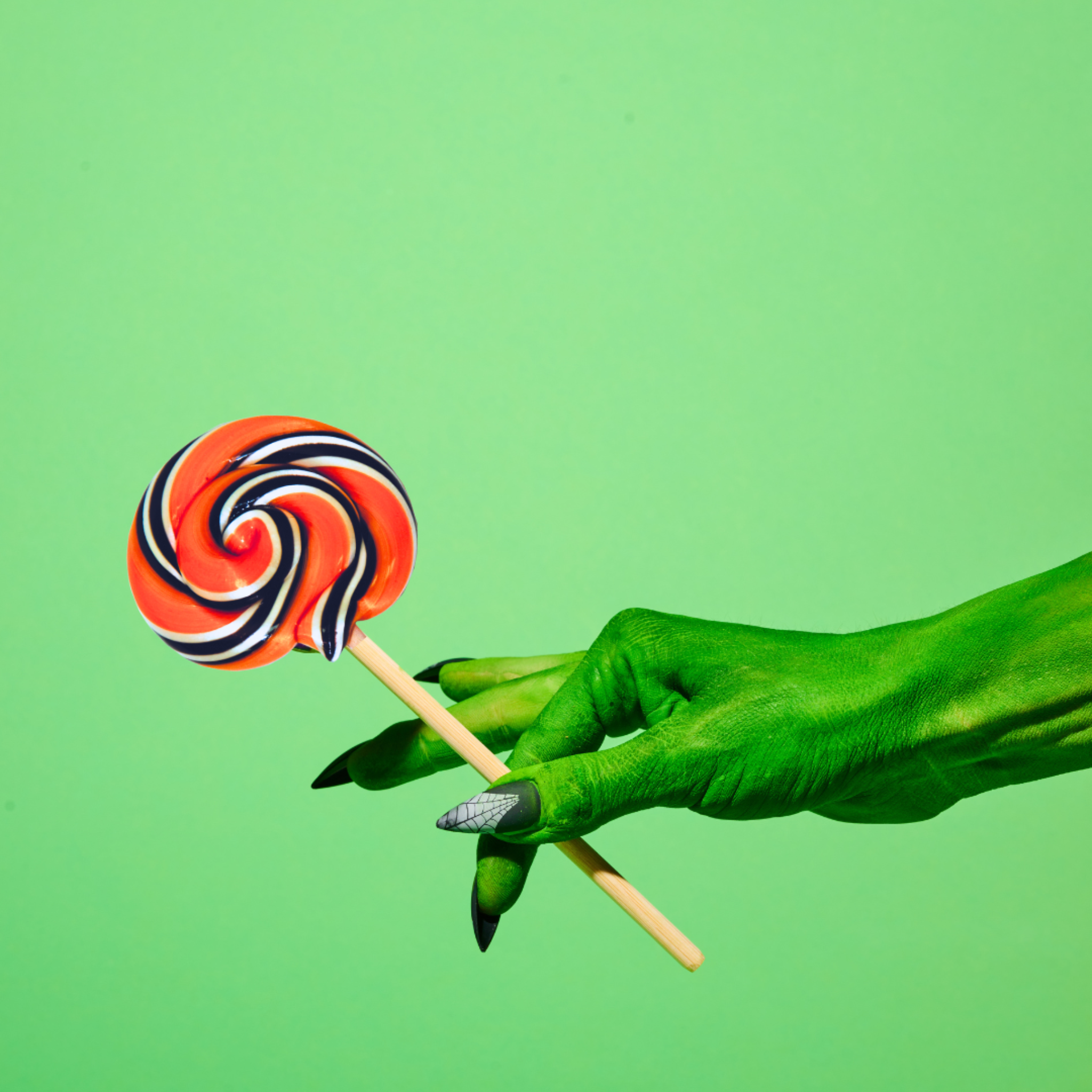 Orange Soda Lollipop in green hand