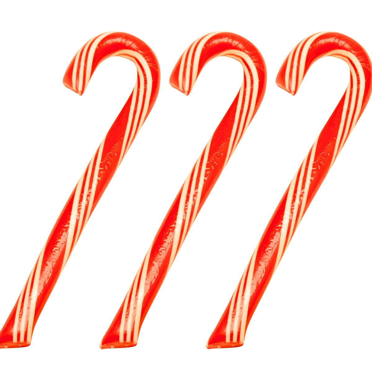 Three red and white striped candy canes on a white background