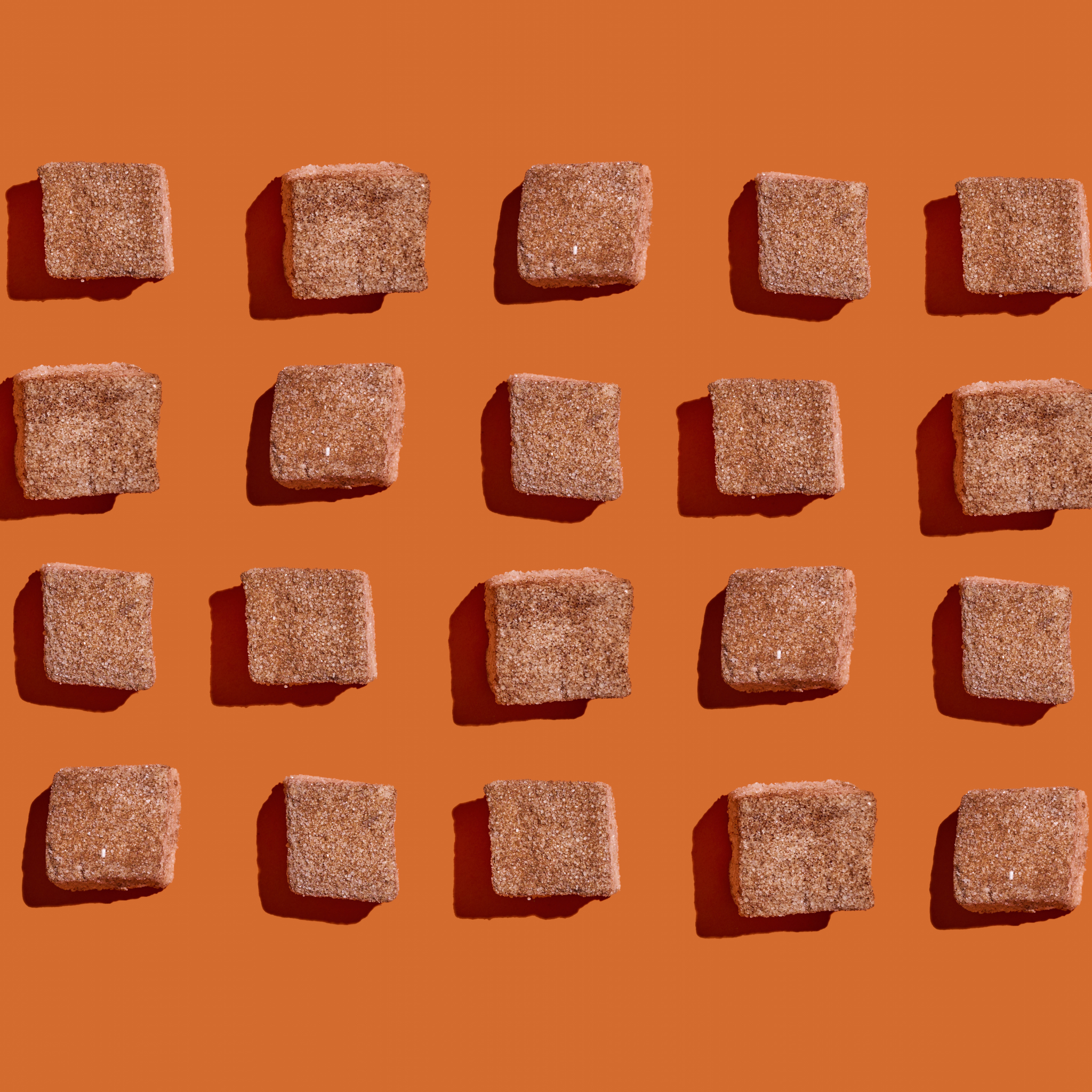Cinnamon churro marshmallow squares on orange background