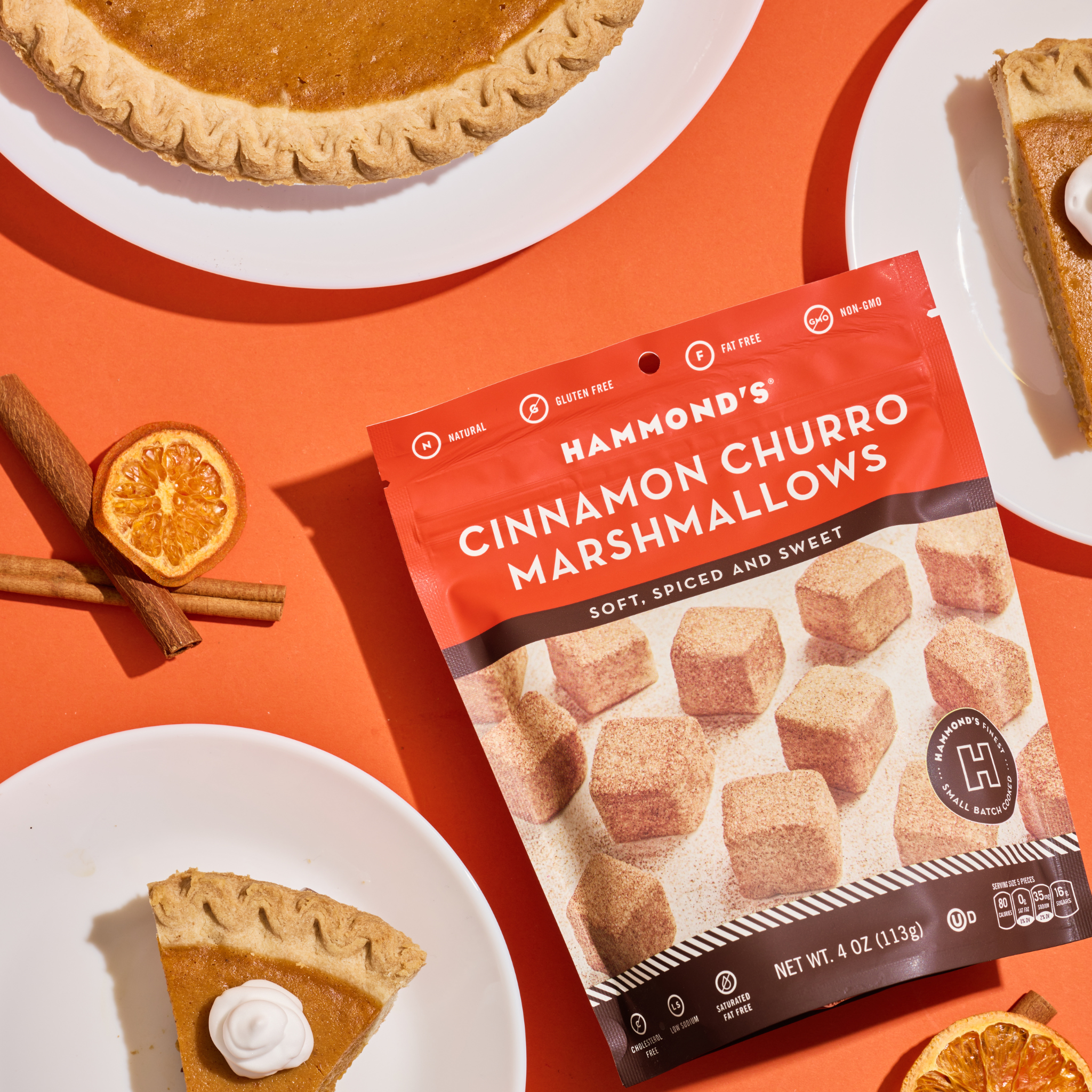Cinnamon churro marshmallows styled with cinnamon, orange slices, and pumpkin pie