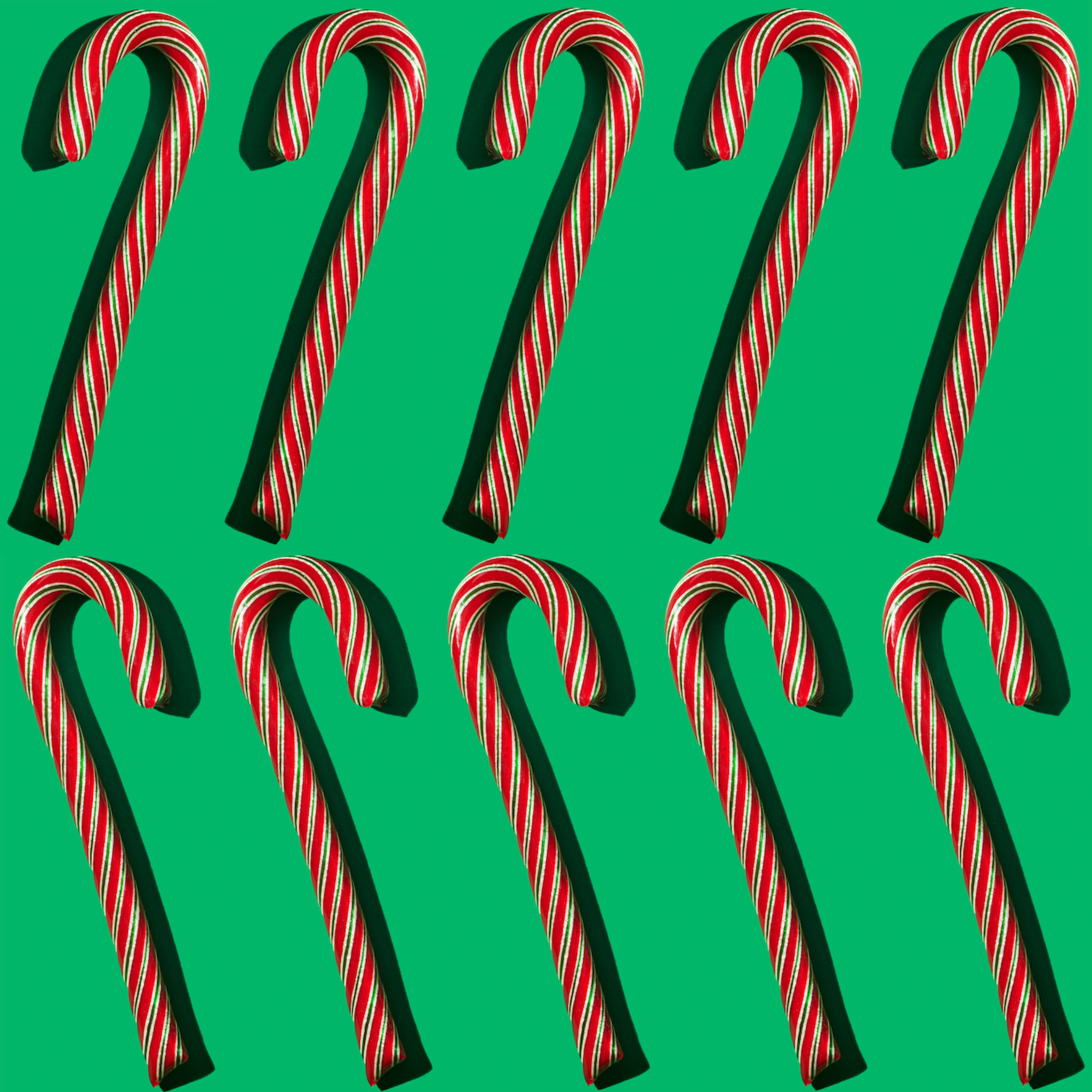 cranberry candy canes styled on green backdrop