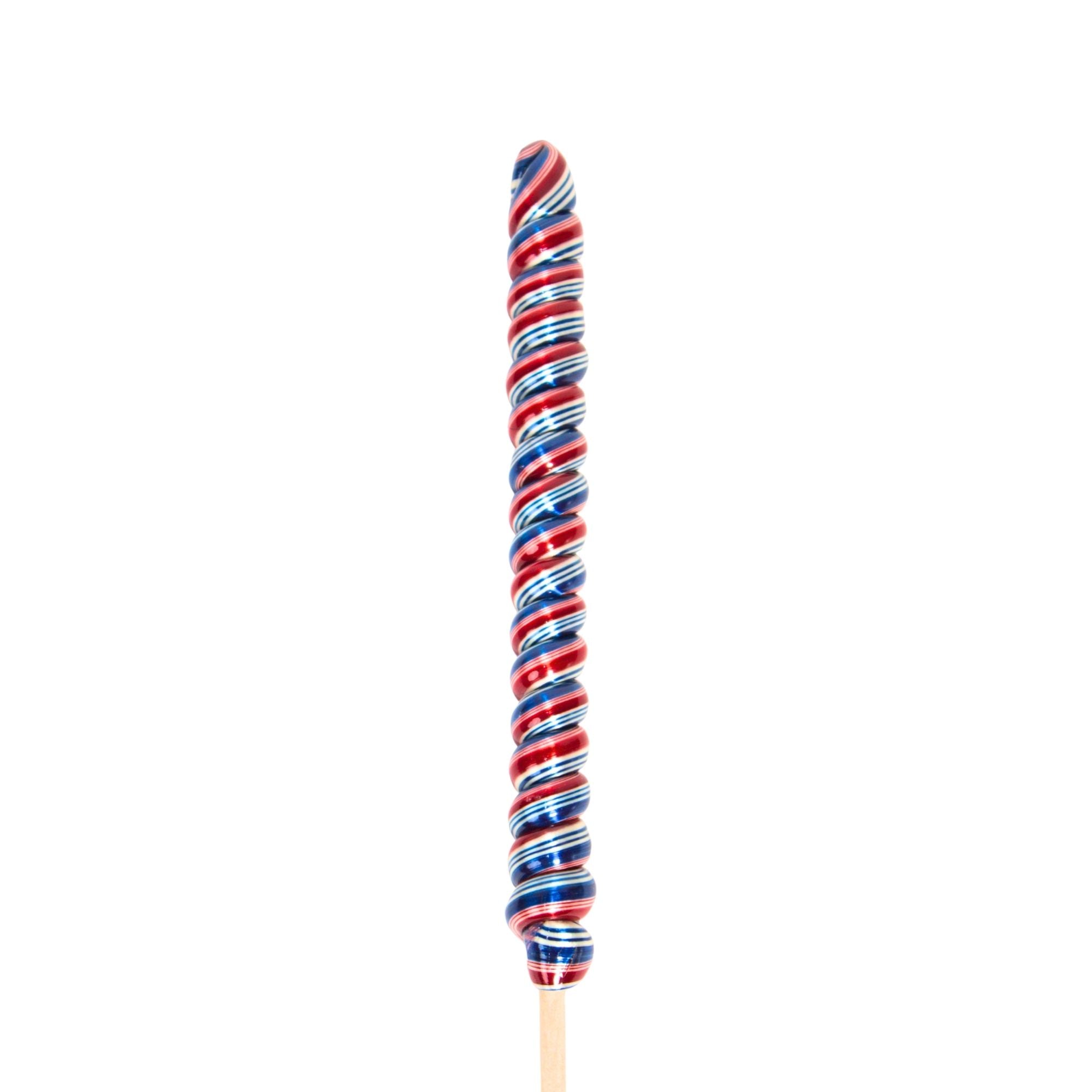Colorful striped candy on a stick against a white background
